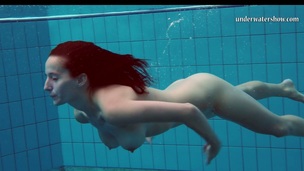 Fire redhead babe Piyavka Chehova swimming naked in a pool