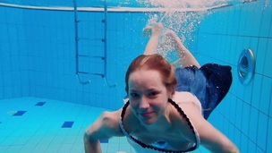 Legal age teenager girl Avenna is swimming in the pool