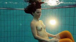 Slim brunette girl Nina Markova swimming stripped in a pool